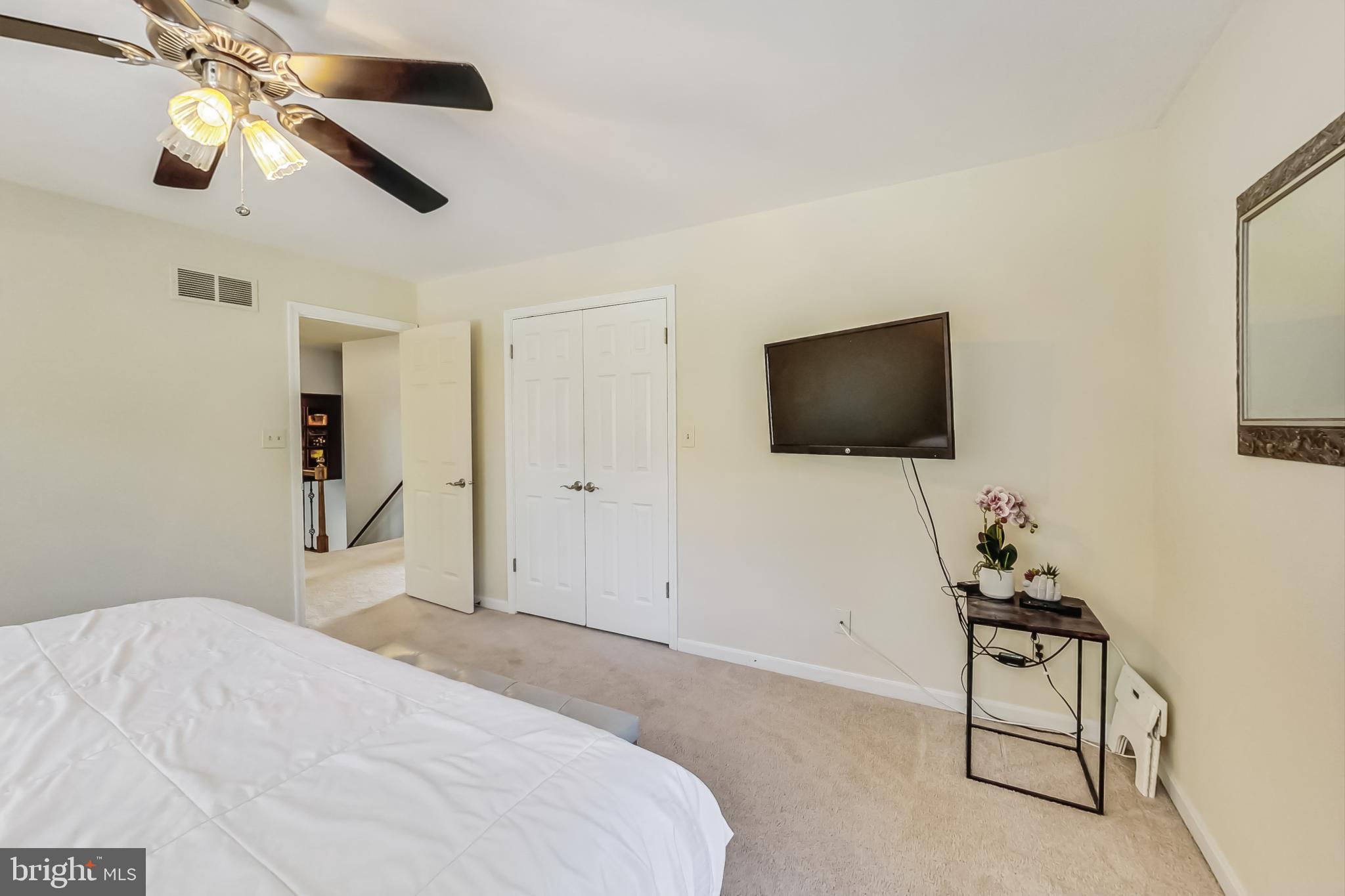 14611 Manor Road Phoenix, MD 21131 - Photo 74 of 85 a bedroom with a bed and a flat screen tv