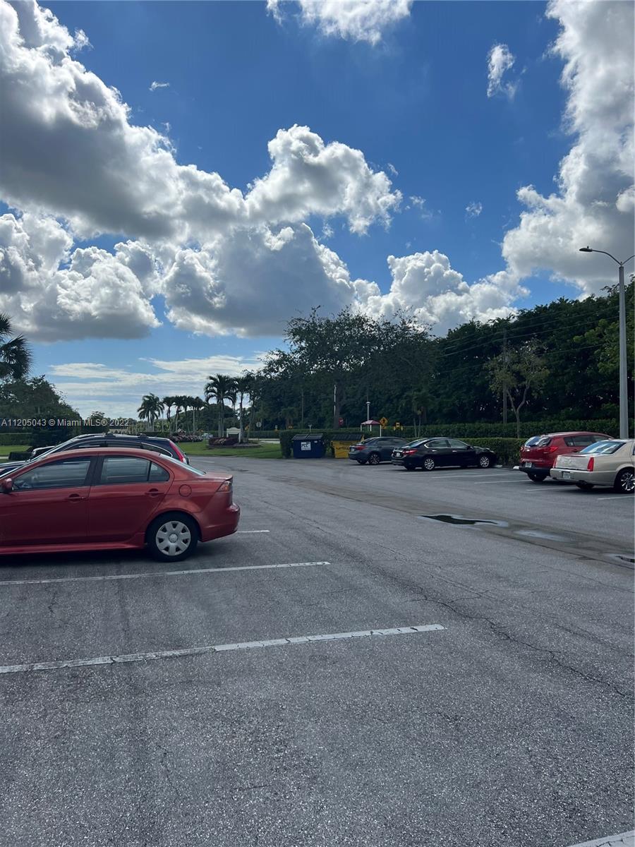 179 Dorset East, Unit 179 Boca Raton, FL 33434 - Photo 13 of 13 a view of street with parked cars