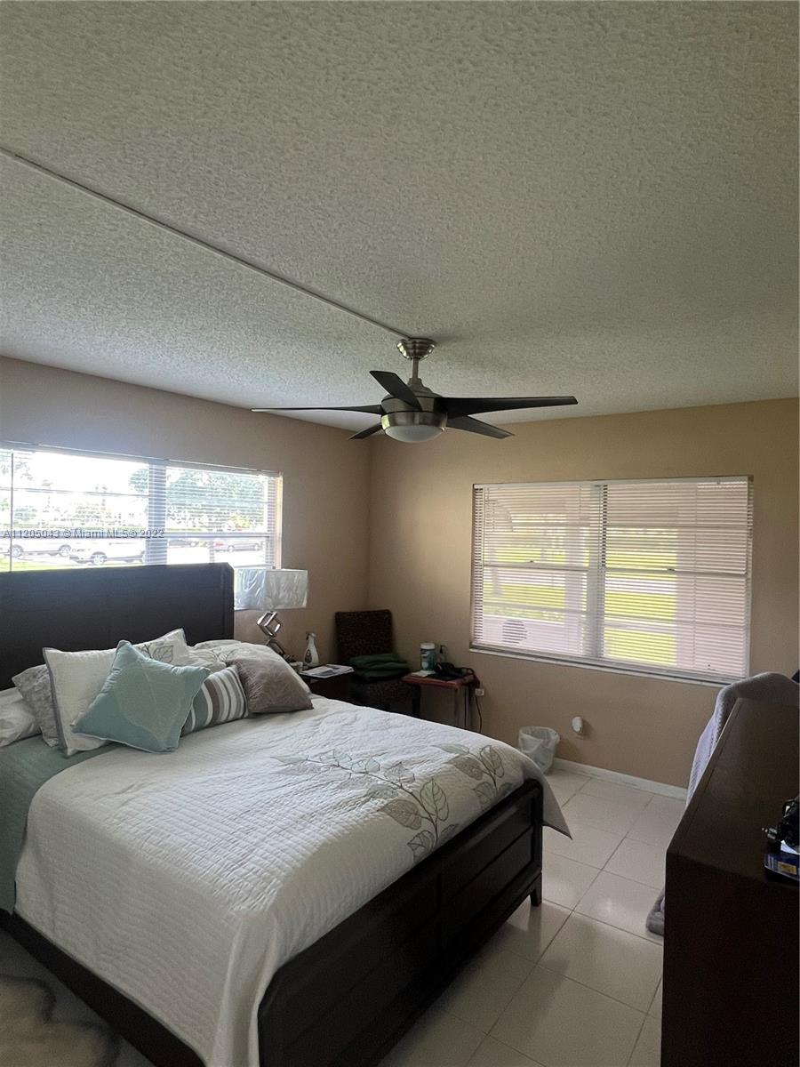 179 Dorset East, Unit 179 Boca Raton, FL 33434 - Photo 6 of 13 a bedroom with a bed and a window