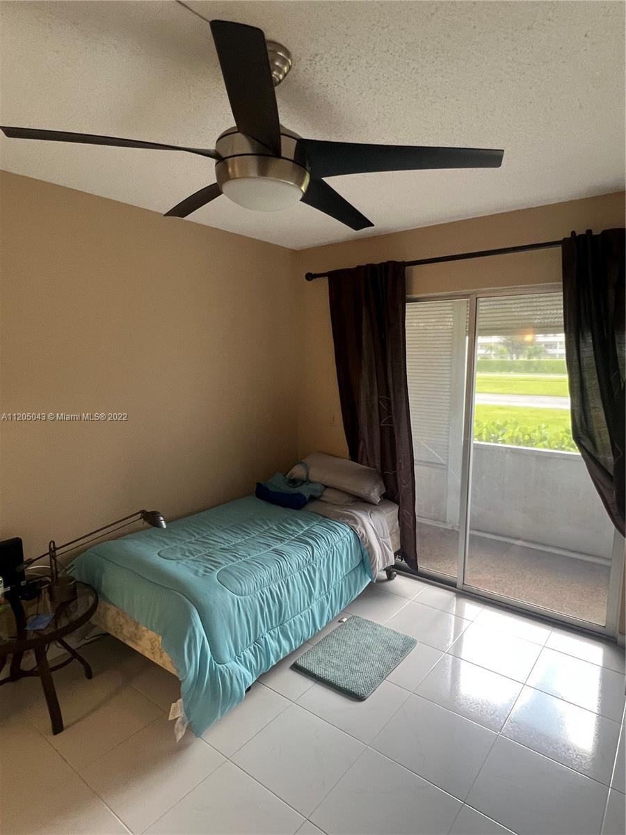 179 Dorset East, Unit 179 Boca Raton, FL 33434 - Photo 8 of 13 a bedroom with a bed and a window