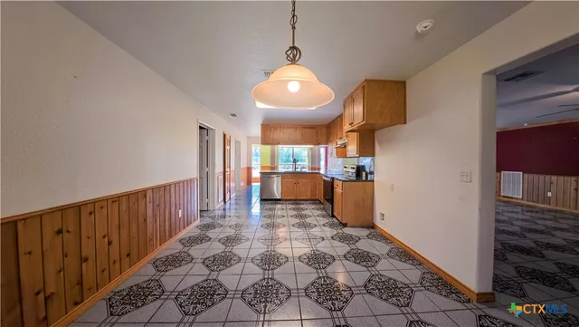 a view of a kitchen with wooden floor
