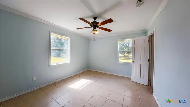 a view of a house with a yard balcony and a tree