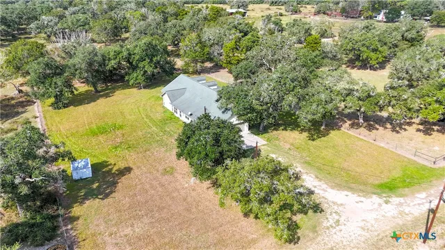 an aerial view of a house with a swimming pool yard and outdoor seating