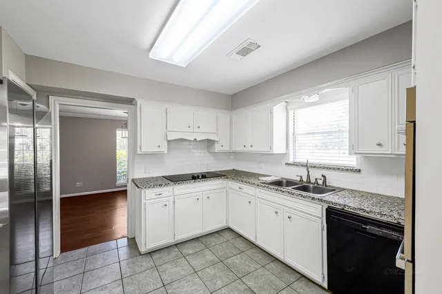 a kitchen with stainless steel appliances granite countertop a sink stove and cabinets