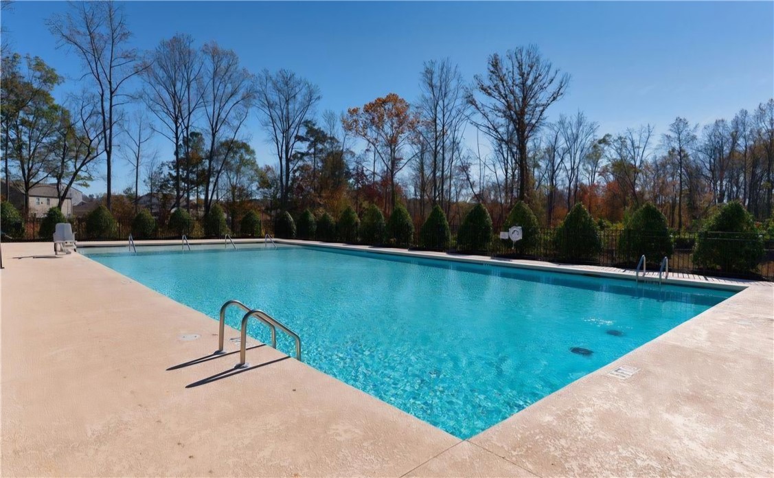 902 Ashwood Lane Easley, SC 29640 - Photo 37 of 39 An inviting outdoor pool awaits, nestled amongst mature trees, perfect for summer relaxation.