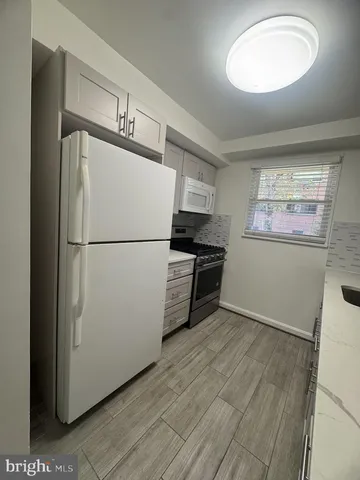 a kitchen with stainless steel appliances a refrigerator and a stove top oven