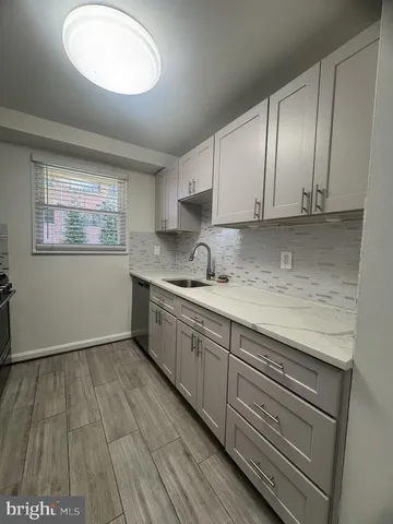 a kitchen with granite countertop white cabinets and white appliances