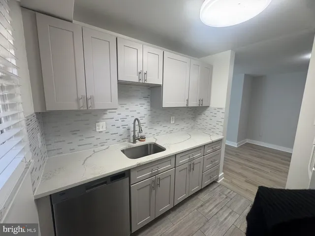 a kitchen with a sink and cabinets