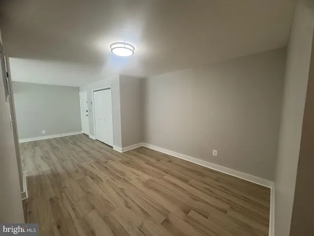 a view of an empty room and wooden floor