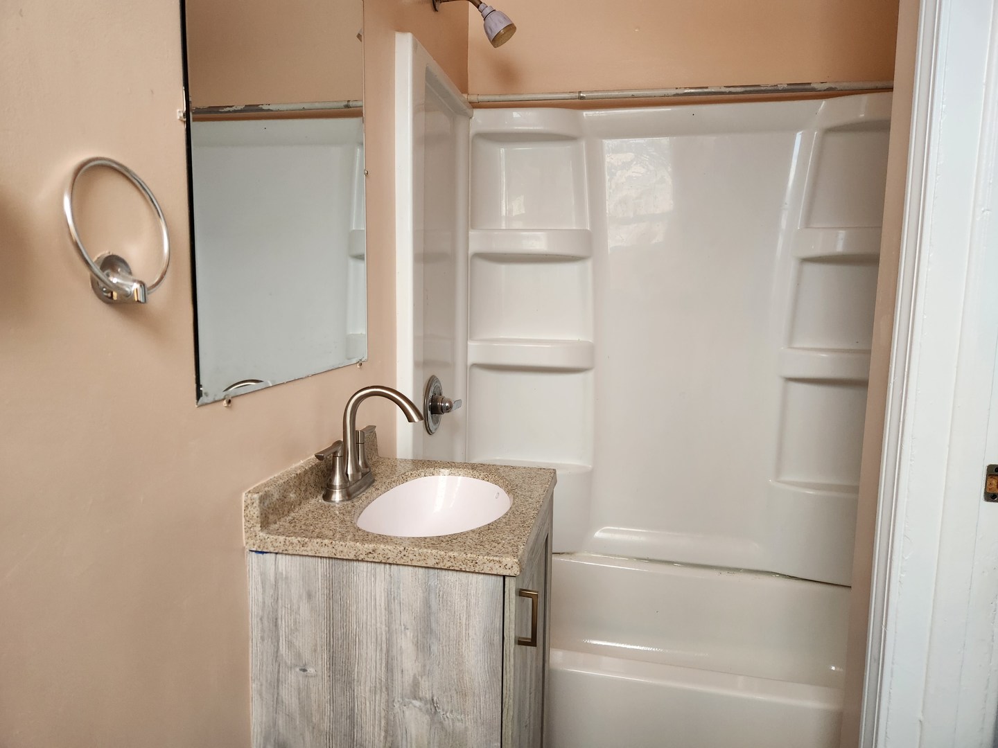 7 National Street, Unit 7 Elgin, IL 60123 - Photo 8 of 10 a bathroom with a granite countertop sink a mirror and shower