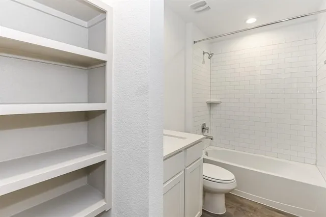 a large kitchen with kitchen island a sink stainless steel appliances and cabinets