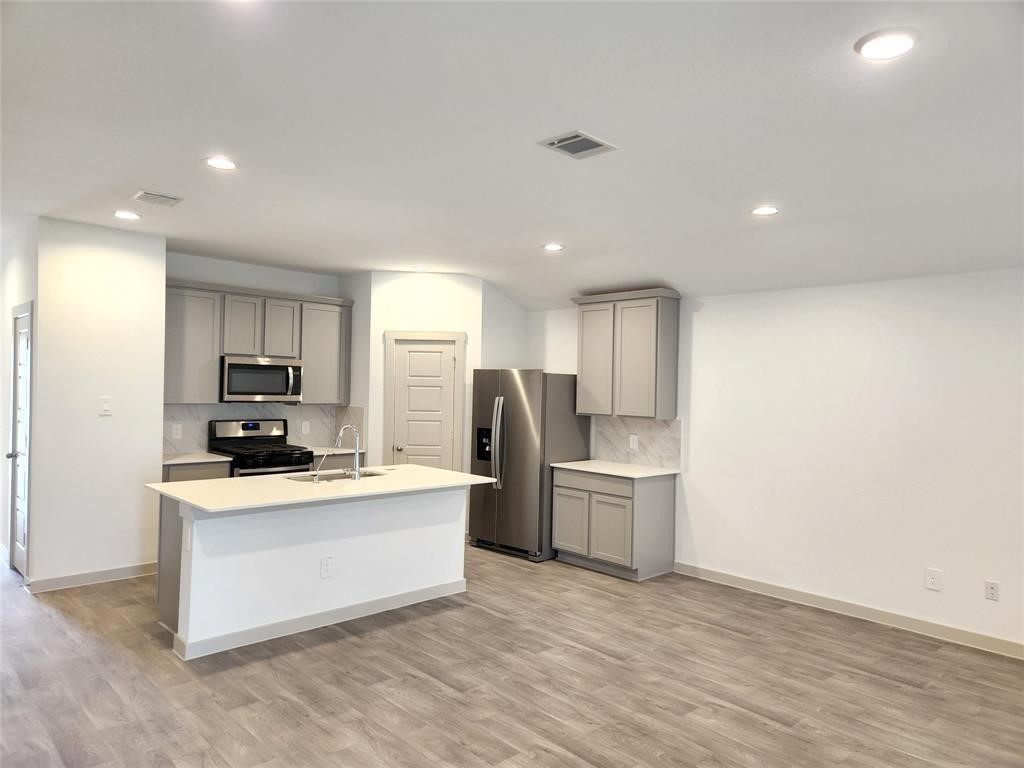 226 Serena Park Lane Rosharon, TX 77583 - Photo 8 of 19 a kitchen with refrigerator and cabinets