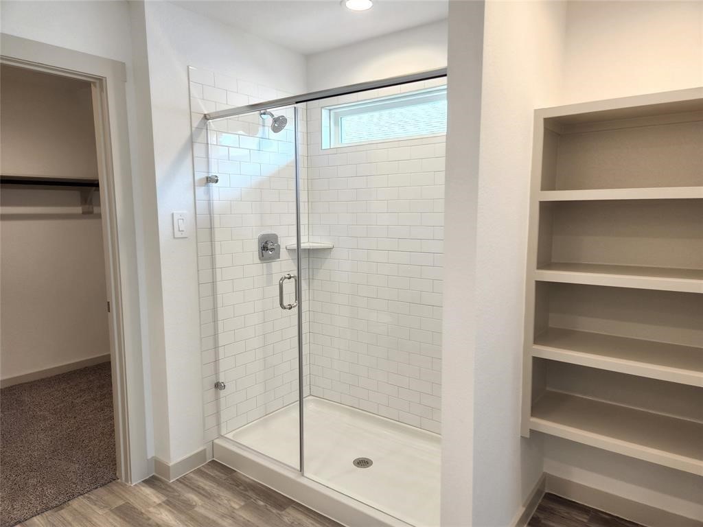 226 Serena Park Lane Rosharon, TX 77583 - Photo 10 of 19 a bathroom with a glass shower door