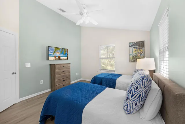 a bedroom with a bed and a painting on the wall