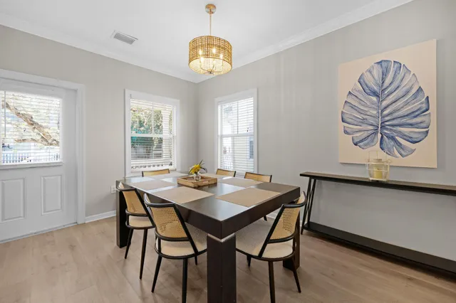 a living room with furniture a chandelier and a window