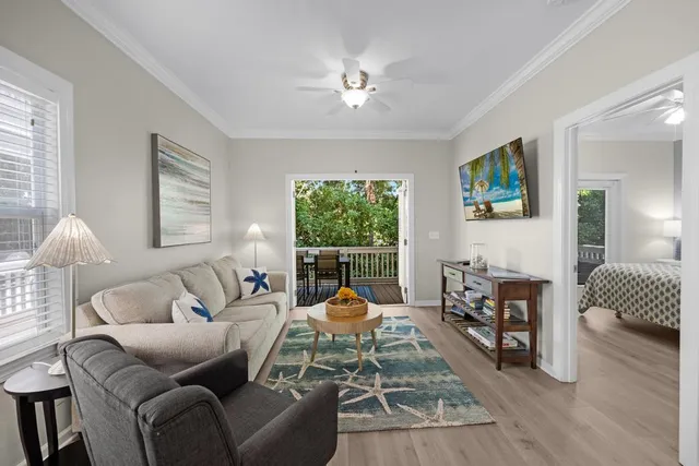 a living room with furniture a chandelier and a window