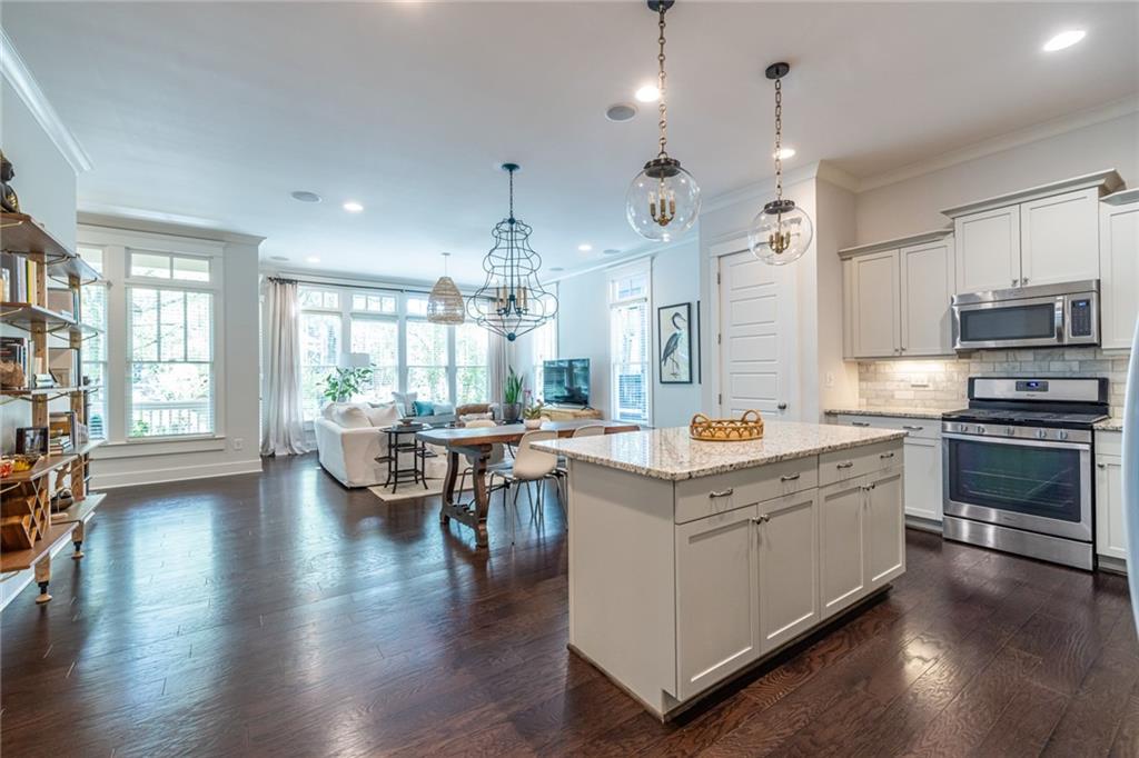 a open kitchen with sink cabinets and wooden floor