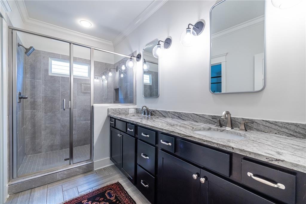 1005 Braeburn Lane Decatur, GA 30030 - Photo 18 of 25 a bathroom with a granite countertop sink a mirror and shower