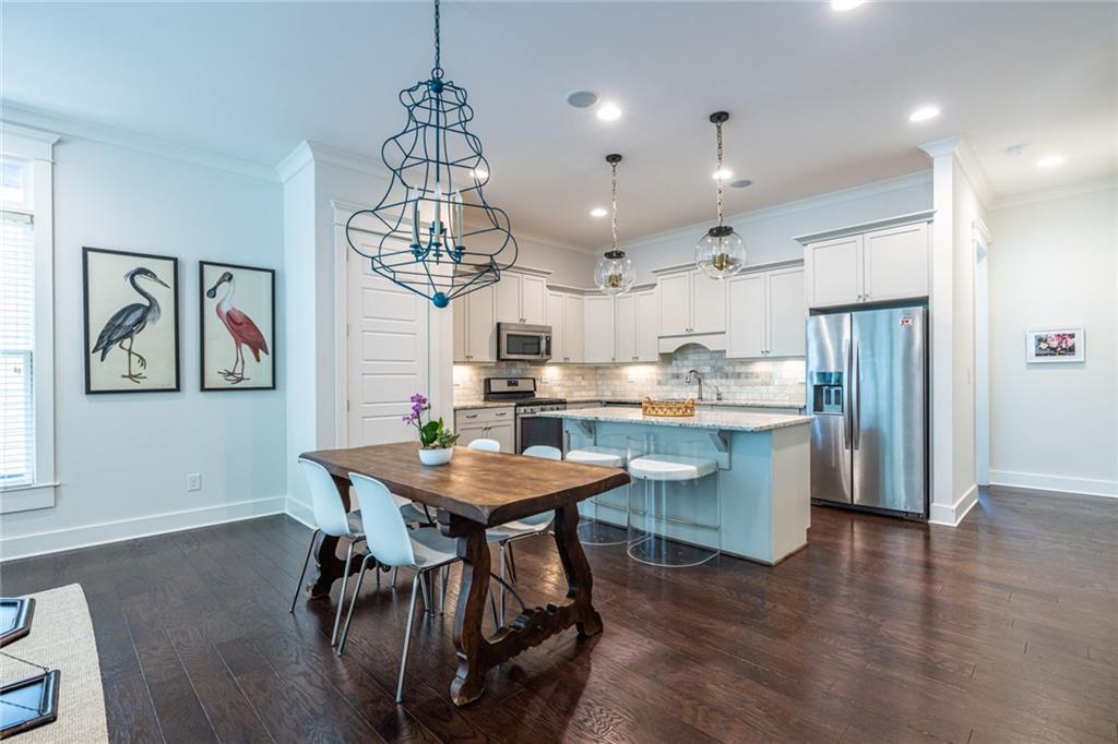 1005 Braeburn Lane Decatur, GA 30030 - Photo 9 of 25 a kitchen with stainless steel appliances kitchen island granite countertop a table chairs and a refrigerator