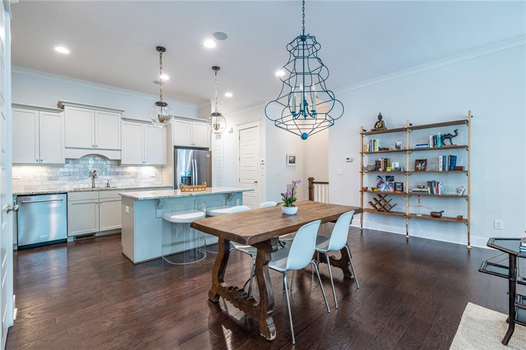 1005 Braeburn Lane Decatur, GA 30030 - Photo 10 of 25 a open dining room with stainless steel appliances kitchen island a table and chairs in it
