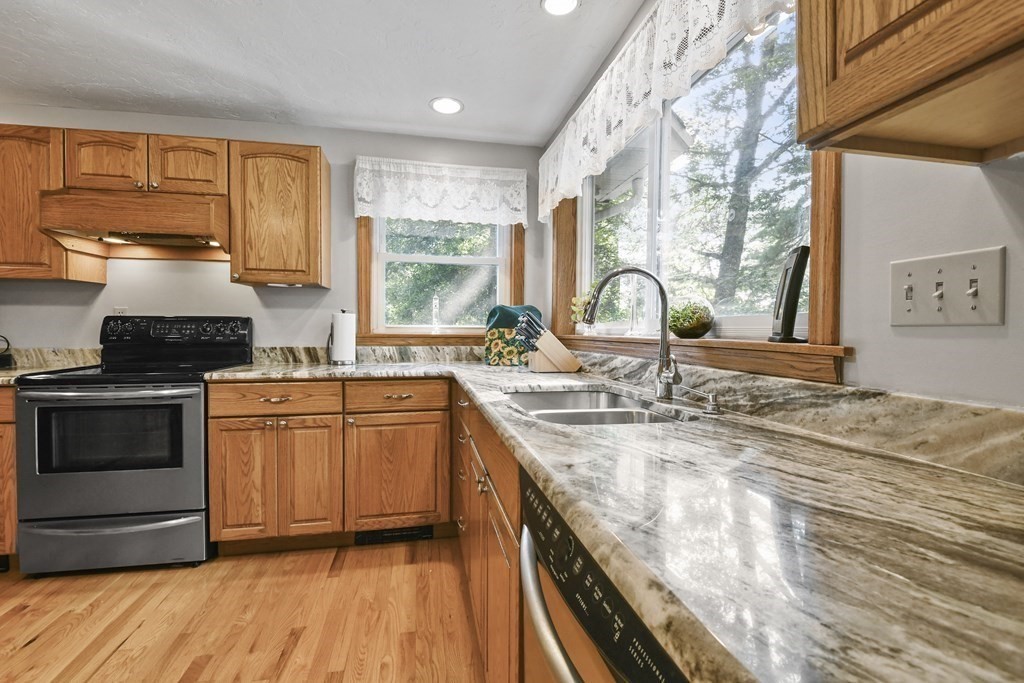 60 Lincoln Point Road Charlton, MA 01507 - Photo 15 of 42 a kitchen with stainless steel appliances granite countertop a stove a sink and a microwave