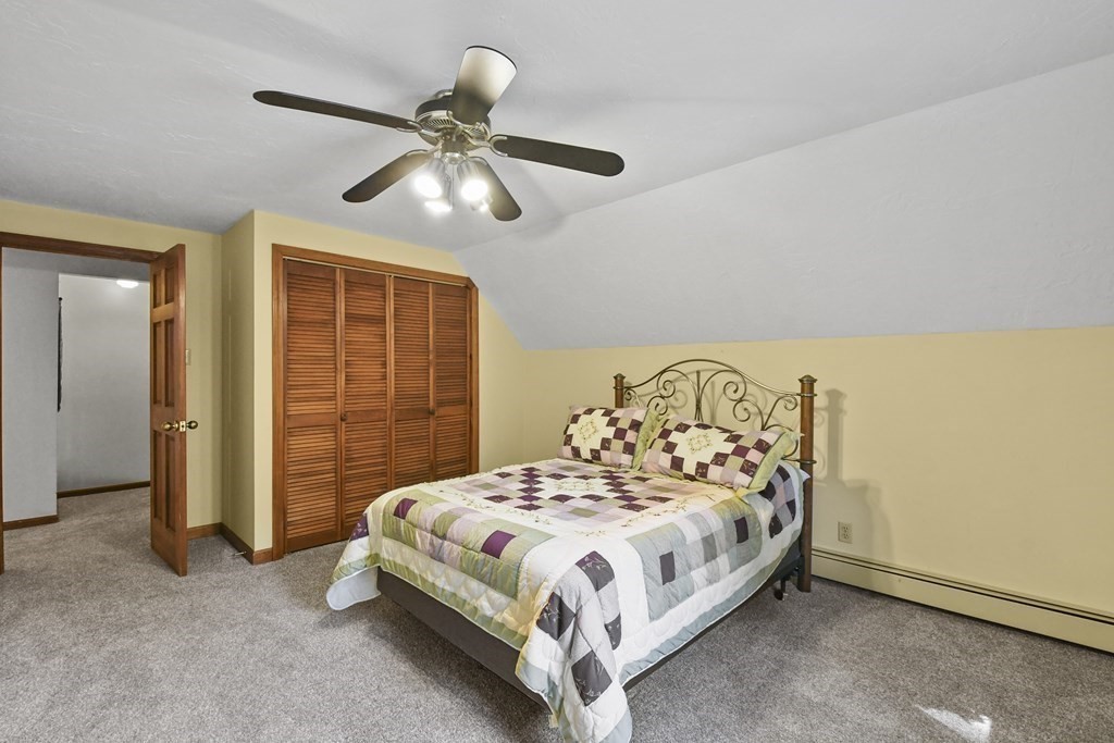 60 Lincoln Point Road Charlton, MA 01507 - Photo 22 of 42 a bedroom with a bed and a chandelier