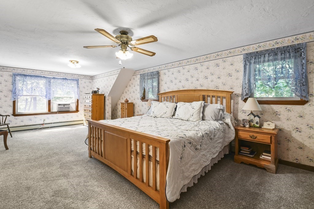 60 Lincoln Point Road Charlton, MA 01507 - Photo 27 of 42 a bedroom with a bed and a chandelier