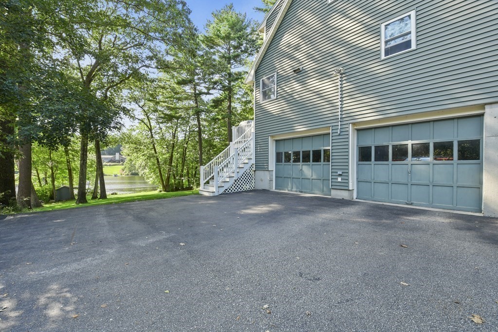 60 Lincoln Point Road Charlton, MA 01507 - Photo 36 of 42 a view of a house with a garden and trees