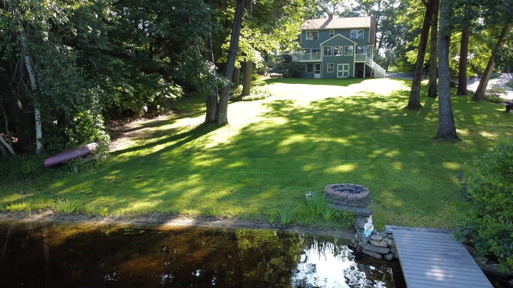 60 Lincoln Point Road Charlton, MA 01507 - Photo 37 of 42 a backyard of a house with table and chairs and wooden fence