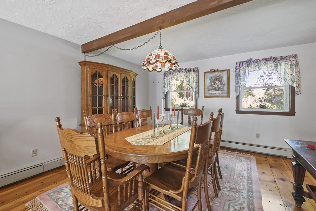 60 Lincoln Point Road Charlton, MA 01507 - Photo 9 of 42 a dining room with furniture a chandelier and wooden floor