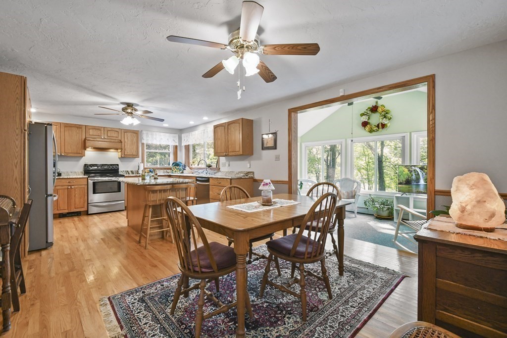 60 Lincoln Point Road Charlton, MA 01507 - Photo 10 of 42 a dining room with furniture a large window and a fireplace