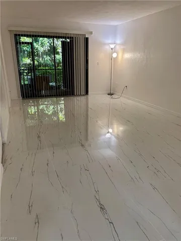 a view of empty room with floor to ceiling windows