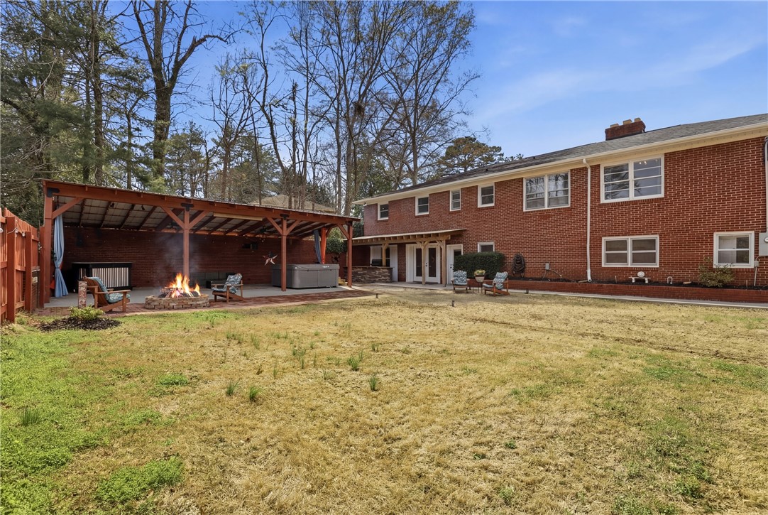 4304 Old Buncombe Road Greenville, SC 29617 - Photo 41 of 49 This spacious yard features a covered patio with a fire pit, ideal for outdoor entertaining.