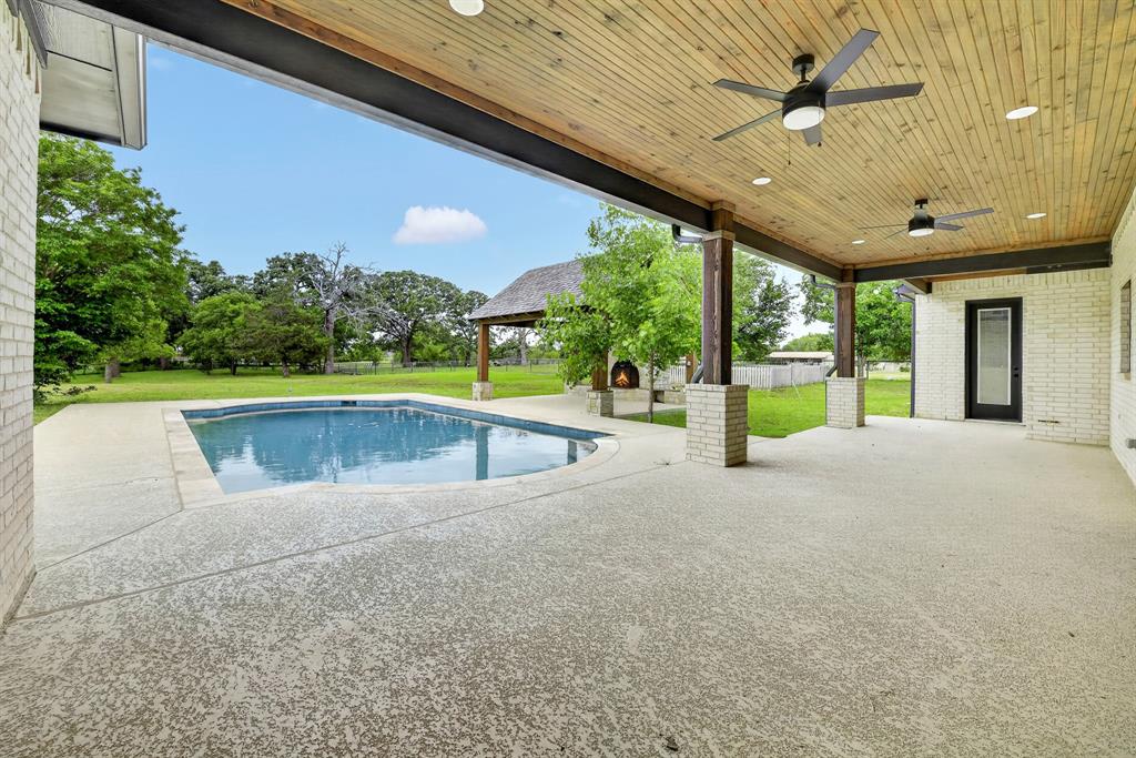 10373 Bobbie Lane Pilot Point, TX 76258 - Photo 30 of 40 Large, oversized back patio with cedar wood cover, ceiling fans and access to indoor pool bath!