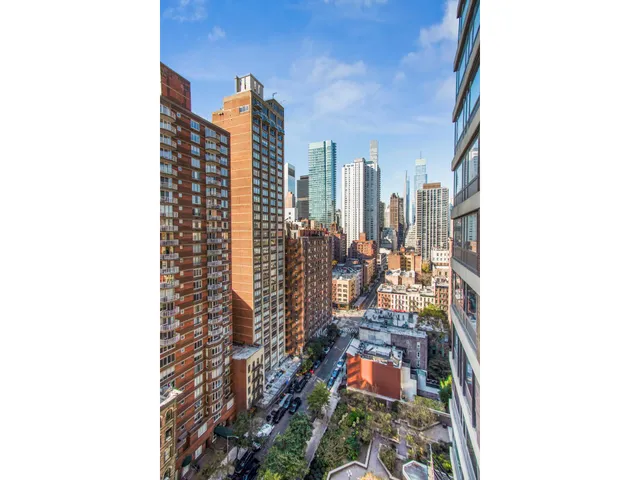 a view of a balcony with chairs and wooden floor