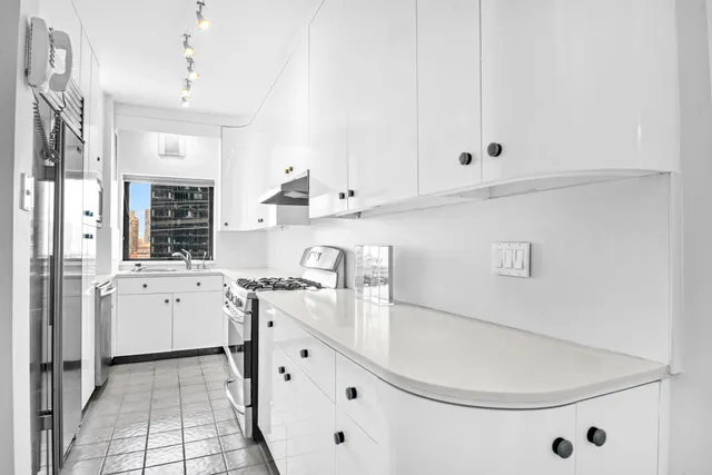 a view of a living room hardwood floor and a window