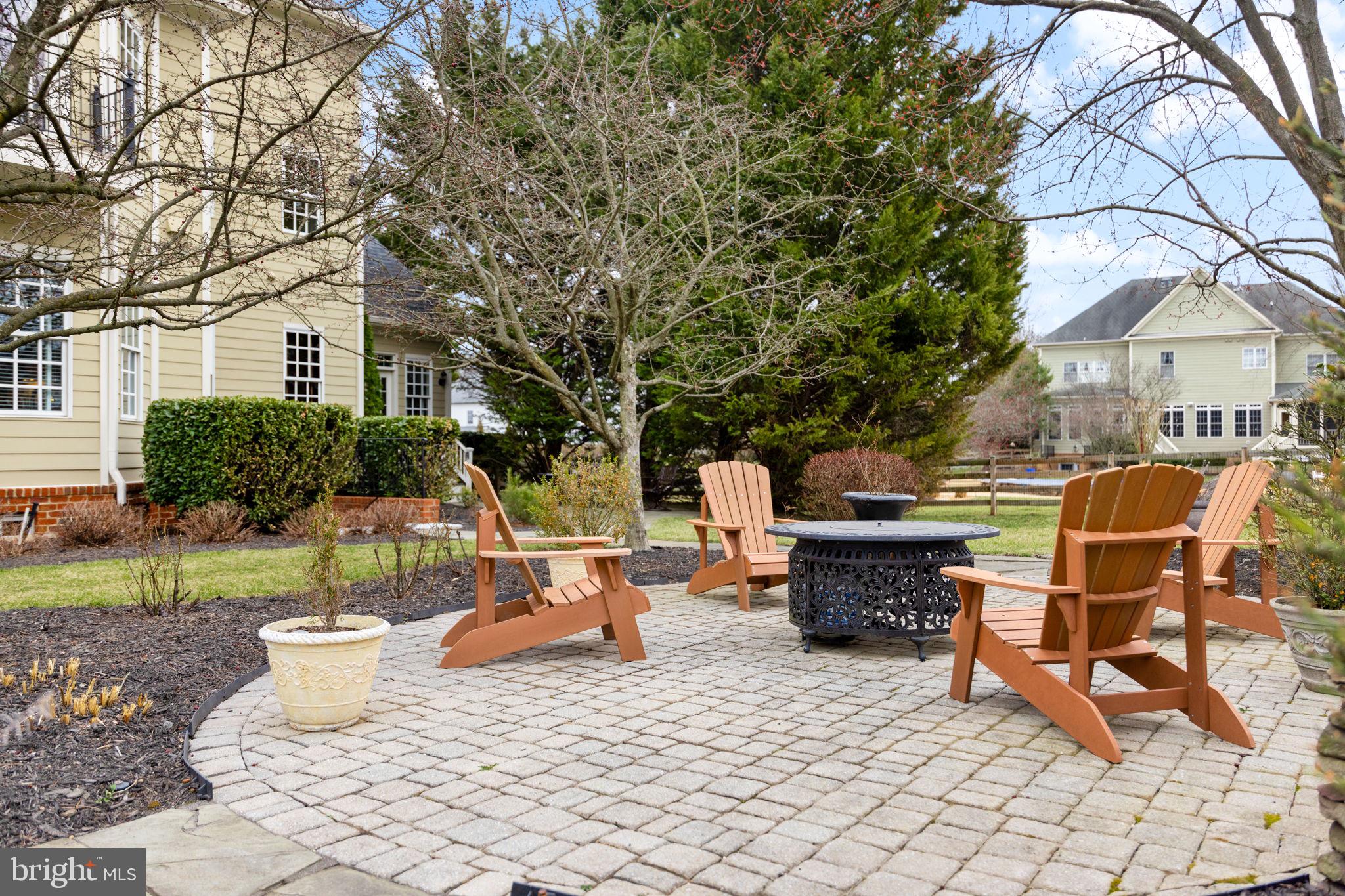 41741 Raspberry Drive Leesburg, VA 20176 - Photo 23 of 117 a view of a patio with table and chairs potted plants and a large tree