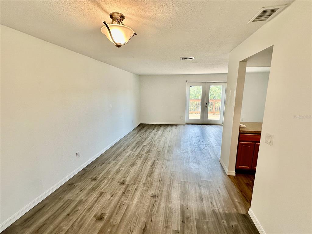 3303 West Shell Point Road, Unit B Ruskin, FL 33570 - Photo 11 of 22 wooden floor in an empty room with a window