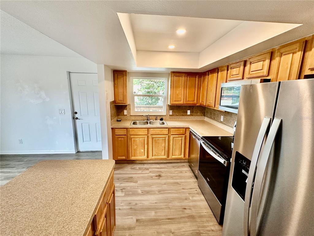 3303 West Shell Point Road, Unit B Ruskin, FL 33570 - Photo 12 of 22 a large kitchen with a stove a refrigerator and a sink