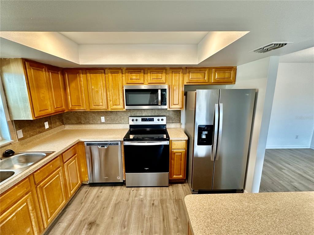 3303 West Shell Point Road, Unit B Ruskin, FL 33570 - Photo 13 of 22 a kitchen with granite countertop a refrigerator and a sink