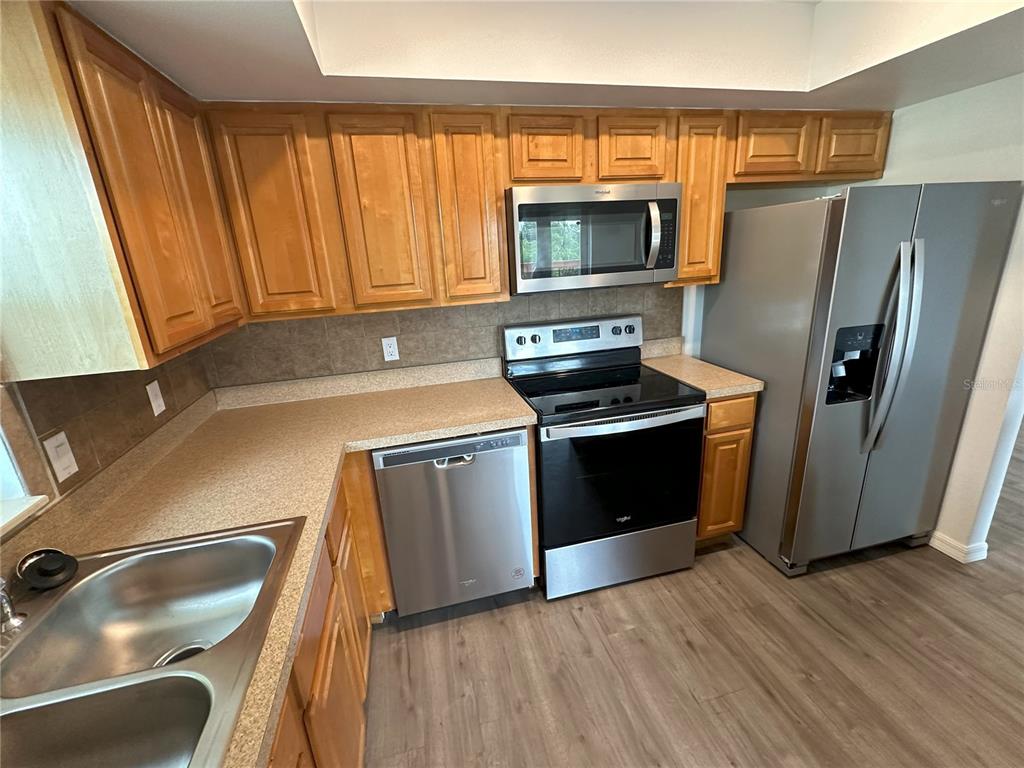 3303 West Shell Point Road, Unit B Ruskin, FL 33570 - Photo 14 of 22 a kitchen with a refrigerator stove and sink