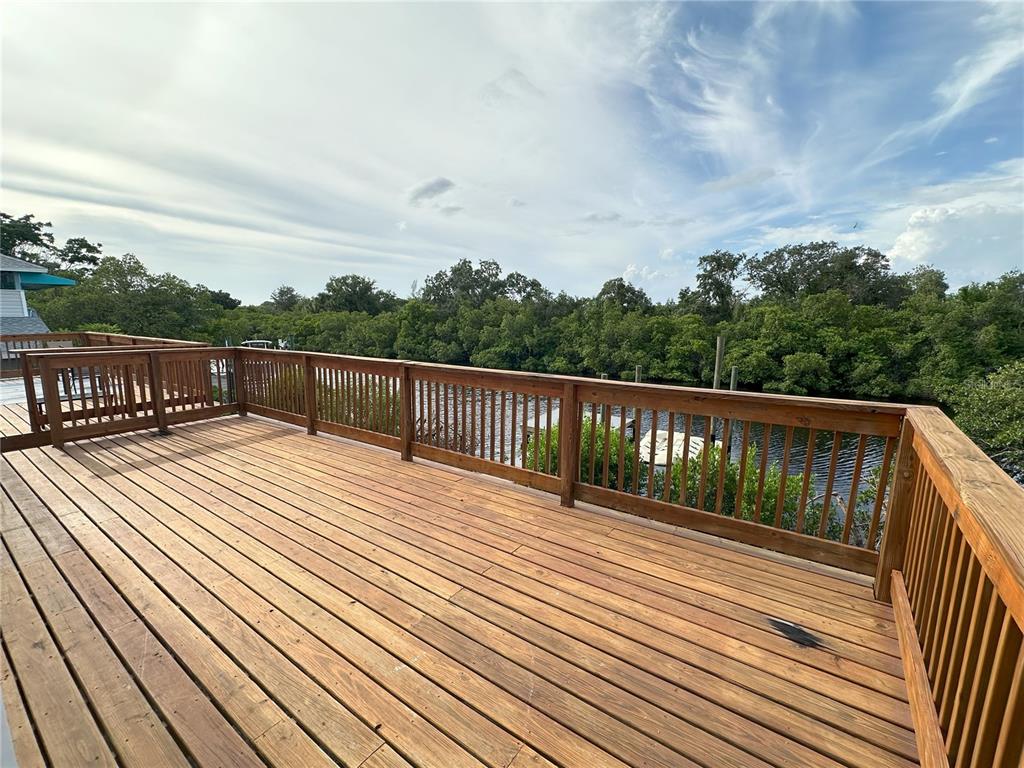 3303 West Shell Point Road, Unit B Ruskin, FL 33570 - Photo 16 of 22 a balcony with wooden floor and fence