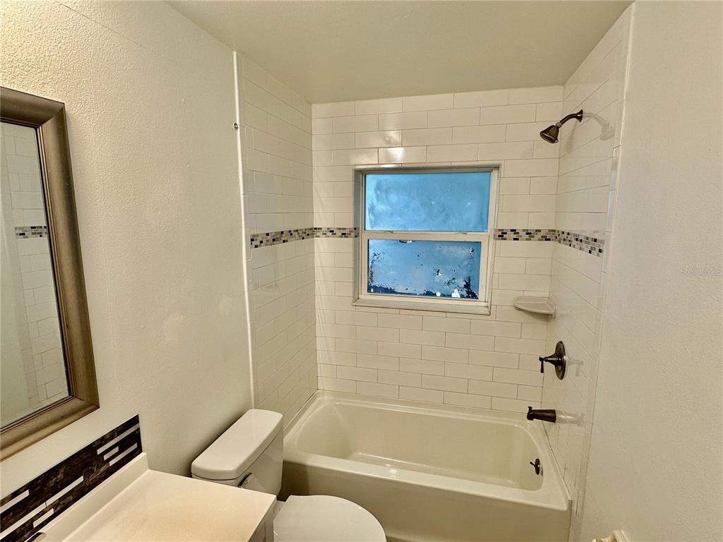 3303 West Shell Point Road, Unit B Ruskin, FL 33570 - Photo 4 of 22 a bathroom with a bathtub and a shower
