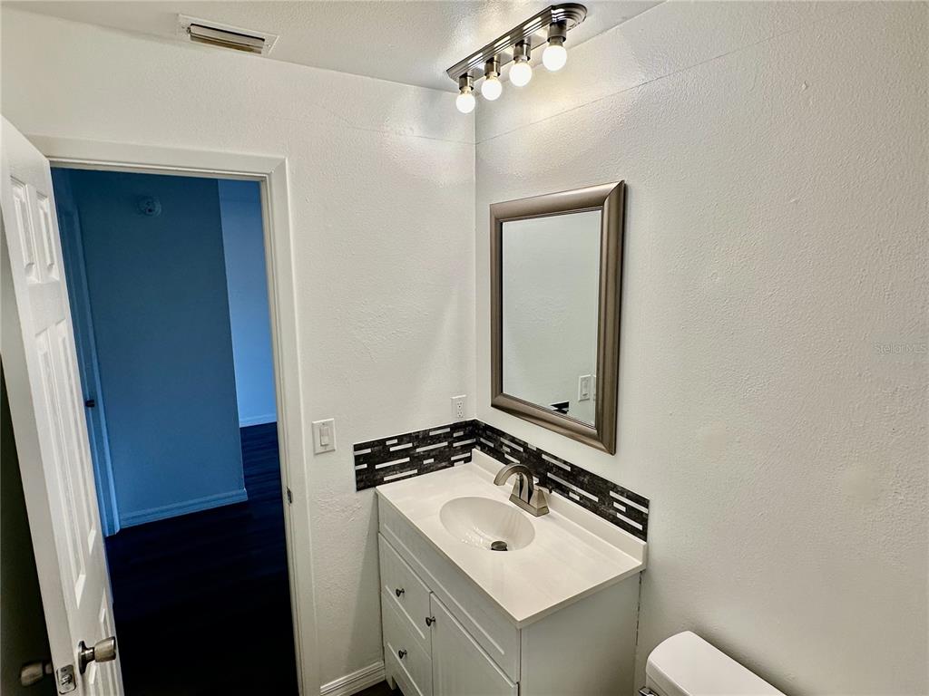 3303 West Shell Point Road, Unit B Ruskin, FL 33570 - Photo 5 of 22 a bathroom with a sink a mirror and a toilet