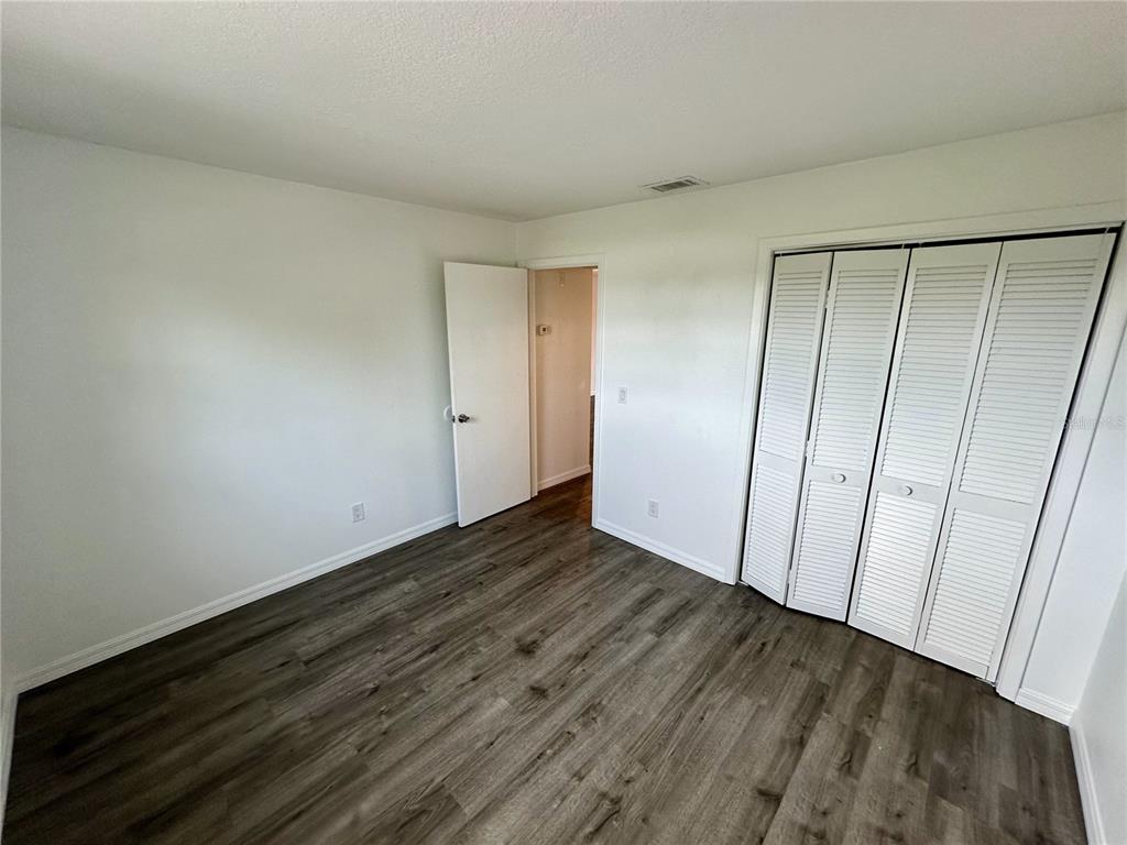 3303 West Shell Point Road, Unit B Ruskin, FL 33570 - Photo 7 of 22 a view of an empty room with wooden floor