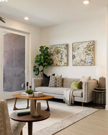 a living room with furniture and a potted plant