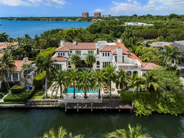 an aerial view of residential houses with outdoor space and lake view