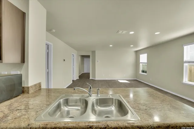 a kitchen with a sink granite counter tops and a granite counter tops