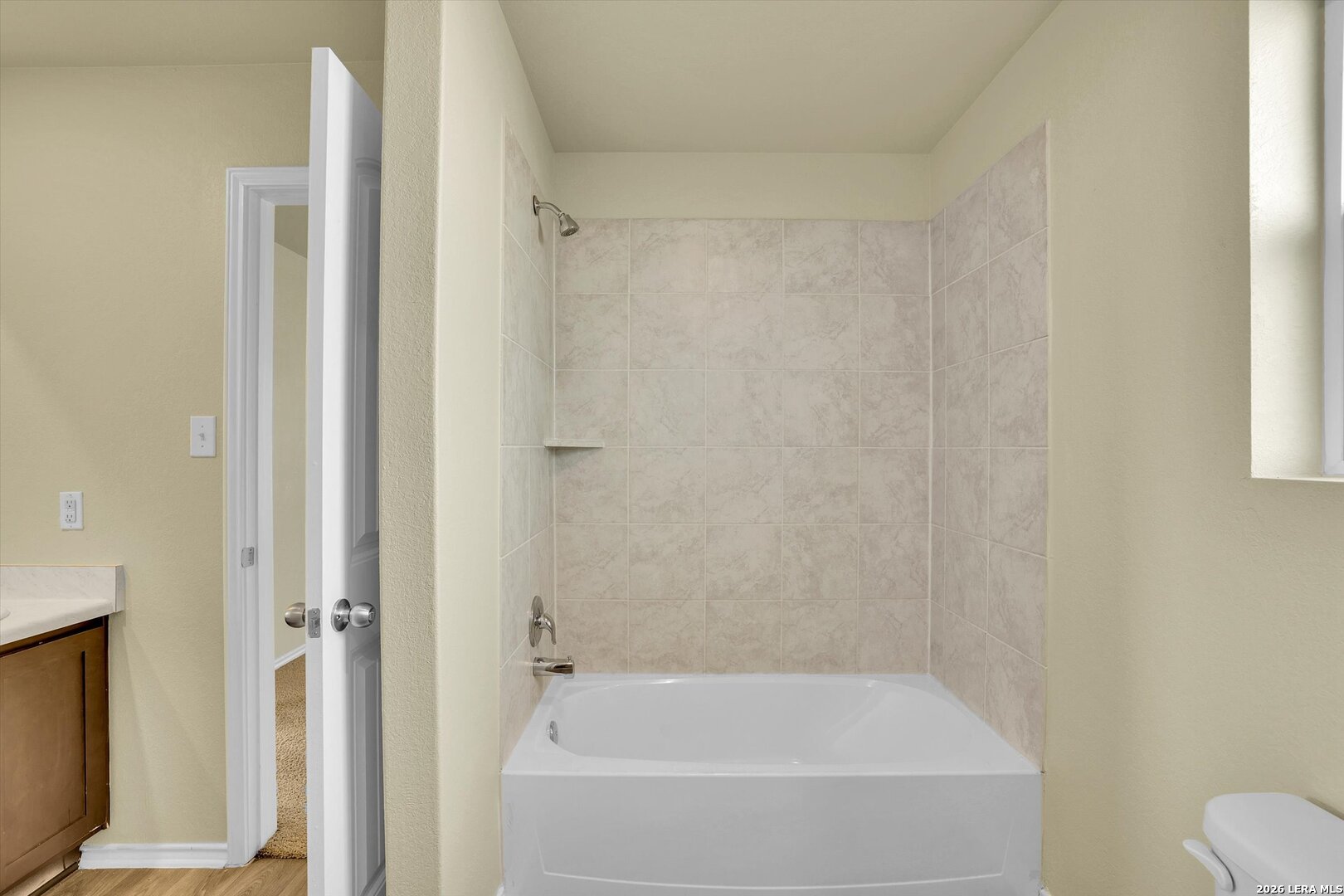 7639 Hercules Point San Antonio, TX 78252 - Photo 18 of 28 a white bath tub sitting next to a white toilet
