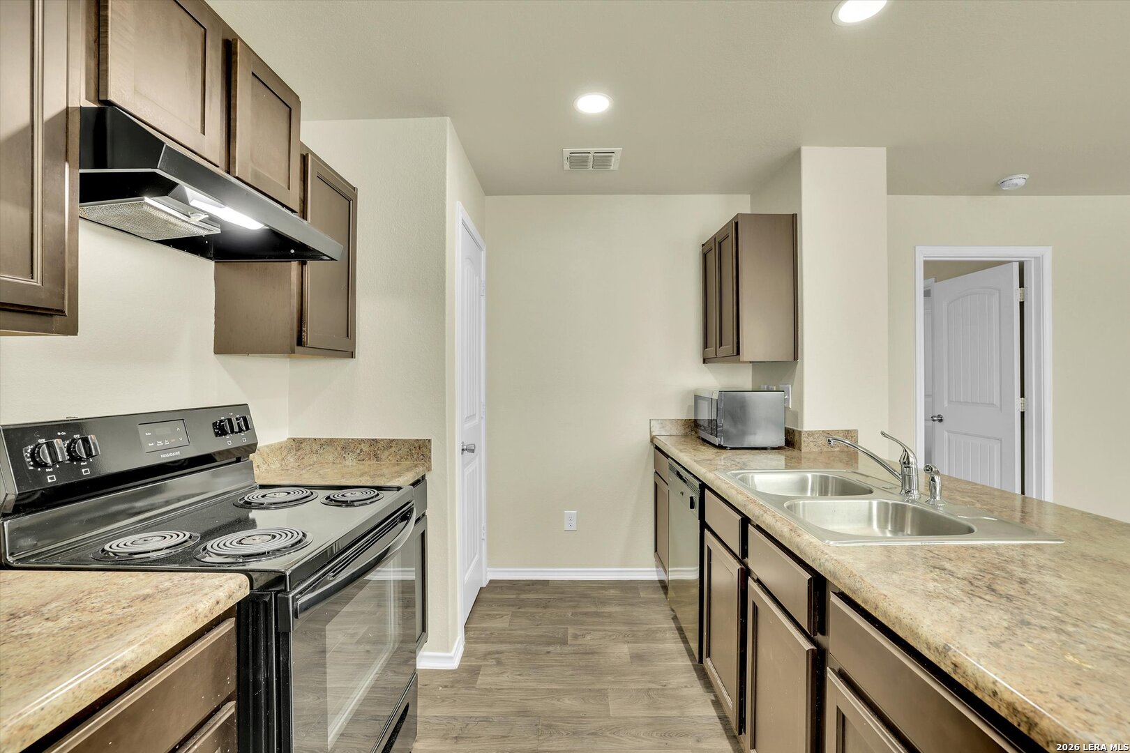 7639 Hercules Point San Antonio, TX 78252 - Photo 9 of 28 a kitchen with stainless steel appliances granite countertop a sink stove and refrigerator